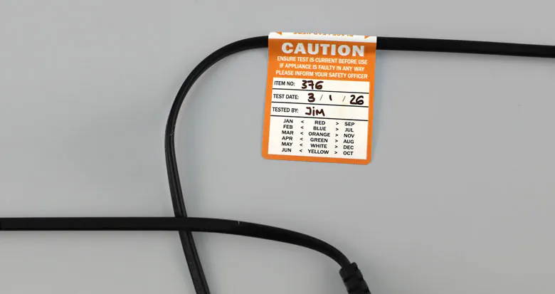 Durable self-laminating test and tag labels by Guru Labels, designed for Australian electrical compliance with protected inspection details for harsh work environments.